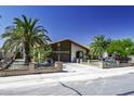 Beautiful home featuring mature palm trees, a lush lawn, and a private fenced yard at 1191 E Avenida Fresca St, Casa Grande, AZ 85122
