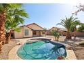 Private backyard features a sparkling pool, desert landscaping, and a covered patio, perfect for relaxation at 12217 W Edgemont Ave, Avondale, AZ 85392