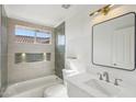 Stylish bathroom showcasing modern fixtures, sleek tiling, and a bathtub with a shower at 12217 W Edgemont Ave, Avondale, AZ 85392