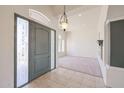 Inviting foyer with neutral tile flooring, decorative columns, and a stylish front door with sidelights at 12721 W Georgia Ave, Litchfield Park, AZ 85340