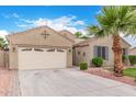 Charming home with a two car garage, desert landscaping, a mature palm tree and extended driveway at 139 E Gail Dr, Gilbert, AZ 85296