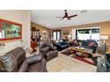 Open-concept living room and dining area with tile floors and ample seating at 15740 N 91St Dr, Peoria, AZ 85382