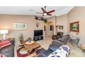 Cozy living room with travertine floors, comfortable seating, and decor at 15740 N 91St Dr, Peoria, AZ 85382