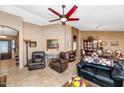 Comfortable living room with tile floors, ceiling fan, and natural light at 15740 N 91St Dr, Peoria, AZ 85382