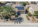 Charming home with solar panels, well-kept landscaping, and a paved driveway at 16186 W Port Royale Ln, Surprise, AZ 85379