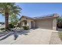 Inviting single-story home featuring a covered porch, desert landscaping, and solar panels at 16186 W Port Royale Ln, Surprise, AZ 85379