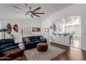 Bright living room with open floor plan, modern furnishings, and access to dining area at 16526 W Desert Ln, Surprise, AZ 85388