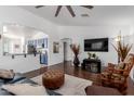 Spacious living room with television, open to the kitchen and dining area at 16526 W Desert Ln, Surprise, AZ 85388