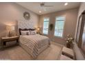 Relaxing bedroom featuring plush carpet and plantation shutters at 16822 W Catalina Dr, Goodyear, AZ 85395