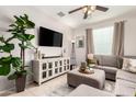 Relaxing living room featuring neutral tones, plush seating, and a large window at 17717 W Mandalay Ln, Surprise, AZ 85388