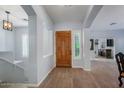 Inviting entryway with a solid wood door, neutral paint, tile flooring, and arched doorways at 1904 E Grand Canyon Dr, Chandler, AZ 85249