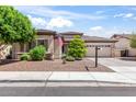 Charming single-story home with desert landscaping and a two-car garage, creating a welcoming curb appeal at 1904 E Grand Canyon Dr, Chandler, AZ 85249