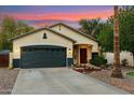 Charming home with a two-car garage, desert landscaping, and a welcoming front entrance at 1924 S Rome St, Gilbert, AZ 85295