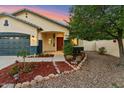 A well-maintained home with desert landscaping, an arched entryway, and a two-car garage at 1924 S Rome St, Gilbert, AZ 85295