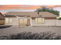 The backyard is a large and inviting space, and has a simple shade covering over the sliding glass door at 20149 N 92Nd Ave, Peoria, AZ 85382