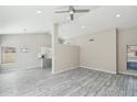 Spacious living room features sleek floors, neutral paint, recessed lighting and a dining area view at 20149 N 92Nd Ave, Peoria, AZ 85382