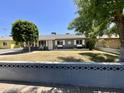 Charming single-story home with a well-maintained lawn and a decorative retaining wall at 2537 E Hazelwood St, Phoenix, AZ 85016