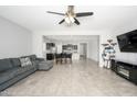 Spacious open concept living room with tile floors flowing into the kitchen and dining areas at 25951 W Piute Ave, Buckeye, AZ 85396
