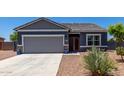 Welcoming single-story home featuring a well-manicured, low-maintenance front yard and a two-car garage at 30388 N Opal Dr, San Tan Valley, AZ 85143