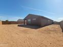 Expansive backyard, enclosed by a brick wall, offers ample space for outdoor activities and customization at 311 S San Gregorio Ln, Casa Grande, AZ 85194