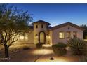 Beautiful home with a tower entrance, desert landscaping, and a paver walkway at 35556 N 87Th Pl, Scottsdale, AZ 85266