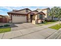 Lovely home exterior featuring a two-car garage, brick accents, and tidy landscaping at 3890 E Perkinsville St, Gilbert, AZ 85295