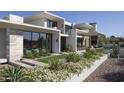 Stunning modern home showcasing meticulous landscaping and sleek architectural design elements at 4451 E Joshua Tree Ln, Paradise Valley, AZ 85253