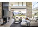Open-concept living area boasting a fireplace, modern decor, and seamless outdoor access at 4451 E Joshua Tree Ln, Paradise Valley, AZ 85253