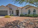 Inviting single-story home with desert landscaping, a rock stream, and a covered porch at 4517 E Ute St, Phoenix, AZ 85044