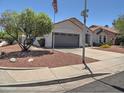 Street view of a well-maintained home with desert landscaping and a two car garage at 4517 E Ute St, Phoenix, AZ 85044