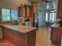 Open concept kitchen with granite countertops, wood cabinets, and stainless steel appliances at 4517 E Ute St, Phoenix, AZ 85044