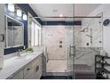 Modern bathroom featuring a glass-enclosed shower with sleek fixtures and marble tile at 4569 E Lariat Ln, Phoenix, AZ 85050