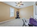 Neutral bedroom features carpet, fan, natural light, and ample space for flexible arrangements at 4607 S Venus --, Mesa, AZ 85212
