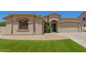 Charming home featuring a well-manicured lawn and a two-car garage, offering curb appeal and convenience at 7008 W Southgate Ave, Phoenix, AZ 85043