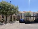 Exterior view of a two-story apartment building with balconies, parking, and mature trees at 7101 W Beardsley Rd # 422, Glendale, AZ 85308