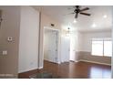 Well-lit living room with wood floors, neutral paint, and a ceiling fan at 7425 N 69Th Ln, Glendale, AZ 85303