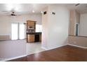 Open-concept living space featuring wood floors, and a kitchen with granite countertops at 7425 N 69Th Ln, Glendale, AZ 85303