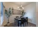 Bright dining area featuring a modern chandelier and decorative olive trees at 9600 N 96Th St # 171, Scottsdale, AZ 85258