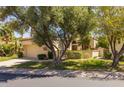 Inviting single-story home with a well-maintained lawn, mature trees and a two-car garage at 10429 N 101St St, Scottsdale, AZ 85258