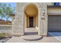 Covered front porch with decorative accents and number plate leads to a secure front door of the home at 10925 E Toluca Ave, Mesa, AZ 85212