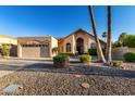 Inviting single-Gathering home features a well-manicured yard and charming desert landscaping at 11085 E Mary Katherine Dr, Scottsdale, AZ 85259