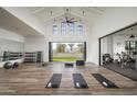 Bright fitness center featuring hardwood floors, modern equipment, and natural light at 11300 N Casa Dega Dr # 1005, Surprise, AZ 85388