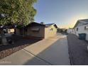 Angle shot of a single-story brick house with large driveway and mature tree at 1428 S Palo Verde Dr, Apache Junction, AZ 85120