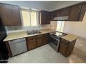 Functional kitchen features dated cabinetry, stainless steel appliances, and natural lighting at 1428 S Palo Verde Dr, Apache Junction, AZ 85120