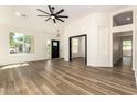 Bright living room boasts wood floors, fresh paint, a modern fan, and lots of natural light at 1710 S Aaron --, Mesa, AZ 85209