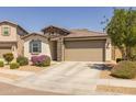Charming single-story home featuring stone accents, desert landscaping, and a two-car garage at 17178 W Buchanan St, Goodyear, AZ 85338