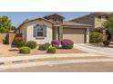 Charming single-story home featuring stone accents, desert landscaping, and a two-car garage at 17178 W Buchanan St, Goodyear, AZ 85338