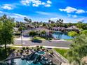 Picturesque aerial view of a waterfront home, lush landscaping, swimming pool, and scenic community at 1724 W Blue Ridge Way, Chandler, AZ 85248