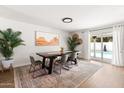 Open dining area with a large table, stylish rug, and sliding glass doors to the pool at 1800 W Shawnee Dr, Chandler, AZ 85224