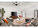 Bright living room with hardwood floors, comfortable sectional sofa, and a modern ceiling fan at 1800 W Shawnee Dr, Chandler, AZ 85224
